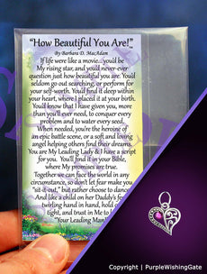 Laminated card with an inspirational poem titled 'How Beautiful You Are,' and a crescent-shaped heart charm with a fuchsia crystal against a purple background.