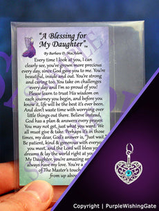 A daughter's blessing on a wallet-size card, and a heart-shaped charm with a Caribbean blue crystal against a purple background.