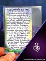 Laminated card with an inspirational poem titled 'How Beautiful You Are,' and a crescent-shaped heart charm with a fuchsia crystal against a purple background.