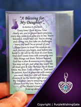A daughter's blessing on a wallet-size card, and a heart-shaped charm with a Caribbean blue crystal against a purple background.
