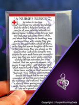 Nurse's blessing card and a crescent-heart-shaped charm with a fuchsia crystal on a purple background.
