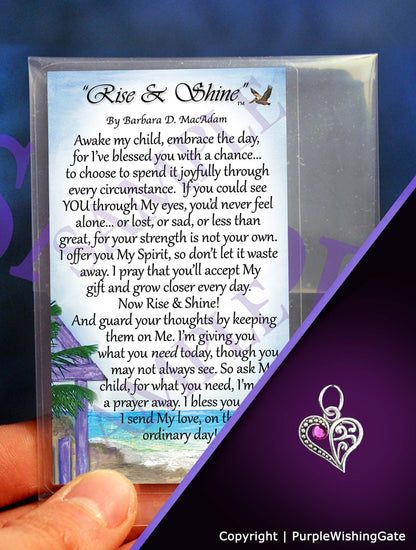 Wallet-size card with 'Rise & Shine' poem and a crescent-heart-shaped charm with a fuchsia crystal on a purple background.