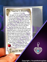 Teacher's blessing card with an apple illustration, plus a heart-shaped charm with a Caribbean blue crystal on a purple background.